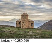 Stone mosque on the background of the dramatic sky. The evening light shines beautifully on the old stone mosque. Hunzah. Dagestan (2021 год). Стоковое фото, фотограф Саблин Станислав / Фотобанк Лори