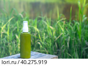 A bottle of spray repellent against blood-sucking insects, mosquitoes, mosquitoes, ticks is outdoor in nature - protecting the skin from bites. UV protection, SPF filter. Comfortable camping. Стоковое фото, фотограф Ольга Симонова / Фотобанк Лори