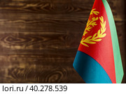 Фрагмент флага Государство Эритрея на цветном деревянном фоне место для текста (2019 год). Стоковое фото, фотограф Лозовая Людмила / Фотобанк Лори