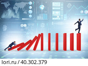Businessman in domino effect concept. Стоковое фото, фотограф Elnur / Фотобанк Лори