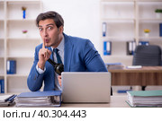 Young male employee drinking alcohol at workplace. Стоковое фото, фотограф Elnur / Фотобанк Лори