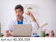 Young male dentist working in the clinic. Стоковое фото, фотограф Elnur / Фотобанк Лори