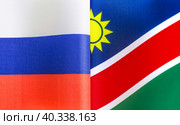Государственные флаги Российской Федерации и Республики Намибия крупным планом. Иллюстрация экономических, политических, культурных отношений (2021 год). Стоковое фото, фотограф Лозовая Людмила / Фотобанк Лори