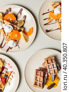 Sweet Belgian waffles with fruits, berries, cream and marshmallows. Top view on a light background, hard light, top view. Стоковое фото, фотограф Bogdanova Mariia / Фотобанк Лори