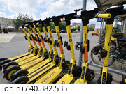 Krasnogorsk, Russia - July 12. 2022 Short-term rental service for electric scooters Yandex Go. Редакционное фото, фотограф Володина Ольга / Фотобанк Лори
