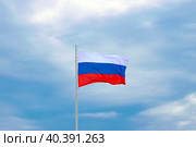 The flag of Russia on a white flagpole against the sky with clouds. Стоковое фото, фотограф Антон Вахрушев / Фотобанк Лори