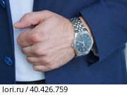 Pskov, Russia - August 09, 2022: - Close up fashion image of Victorinox watch on rest of man's: man's hand in blue casual jacket. Редакционное фото, фотограф Ирина Старикова / Фотобанк Лори