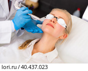 Female client receiving face skin laser resurfacing at cosmetology clinic. Стоковое фото, фотограф Яков Филимонов / Фотобанк Лори