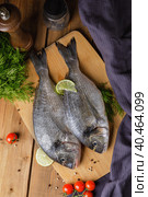 Raw peeled dorado fish with cooking ingredients. Fresh fish on a wooden background. Стоковое фото, фотограф Юрий Поздников / Фотобанк Лори