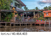 A serene warren of canals, floating houses and stilt houses over the Chao Phraya River, at Krung Thon Bridge (Saphan Sang Hi) (2019 год). Стоковое фото, фотограф Анна Кривицкая / Фотобанк Лори