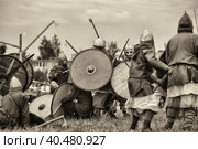 Russia, Staraya Ladoga 23,06,2012 Reenactors with shields and spears during the battle, the festival of historical reconstruction "Pages of History" Стоковое фото, фотограф Анна Кривицкая / Фотобанк Лори