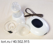 Isolated electric portable breast pump with blank bottle and replaceable nipple for feeding newborn. Стоковое фото, фотограф Яков Филимонов / Фотобанк Лори
