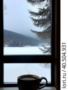 Morning fragrant coffee on the background of a frosty winter morning and a winter landscape outside the window. Стоковое AI-изображение, AI-художник Сергей Елизарьев / Фотобанк Лори