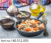 Devzira pilaf with lamb, onions, carrots and spices (cumin, coriander, pepper). Traditional dishes of Uzbek cuisine. Selective focus. Стоковое фото, фотограф Виктория Панченко / Фотобанк Лори