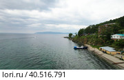 The shore of Lake Baikal near the village of Listvyanka on a summer day. Берег озера Байкал недалеко от деревни Листвянка летним днем. Стоковое видео, видеограф Виктория Тельминова / Фотобанк Лори