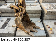 The excavator bucket lies on concrete blocks. Стоковое фото, фотограф Iva Noel / Фотобанк Лори