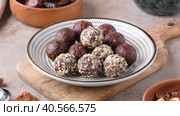 Zoom in homemade raw chocolate energy balls of dates, cocoa, coconut sprinkles and chopped  hazelnut. Healthy vegan and vegetarian food. Sugar free nutrition. 4K video. Стоковое видео, видеограф Мария Зубарева / Фотобанк Лори
