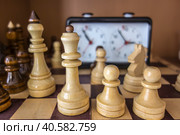 Шахматный турнир, деревянная доска, фигуры, таймер/ Chess background with a wooden board, chess pieces and clock. Стоковое фото, фотограф Iva Noel / Фотобанк Лори