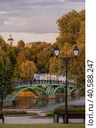 Summer evening Tsaritsyno Park in Moscow. View of the fountain and the church at sunset. Tsaritsyn Park is one of the main tourist attractions of Moscow. Russia, May 2023. Редакционное фото, фотограф Photojuli / Фотобанк Лори