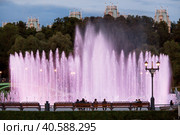 Light and music fountain on a summer evening. Natural Museum-reserve "Tsaritsyno". Colorful fountain in Tsaritsyno Park at night. (2023 год). Редакционное фото, фотограф Photojuli / Фотобанк Лори