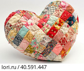 Multicolored pillow made of heart-shaped patches. Created by AI. Стоковое AI-изображение, AI-художник Ярославский Максим / Фотобанк Лори