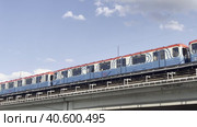 Moscow metro trains meet on the Preobrazhensky metro bridge against the background of clouds. Sokolniki district. Moscow. 08.06.2023. Стоковое видео, видеограф Ярославский Максим / Фотобанк Лори