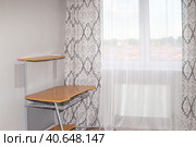 Bright room with a curtained window, a computer desk near a gray wall. The interior of a small room. Стоковое фото, фотограф Коханова Наталья / Фотобанк Лори