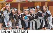 Smiling female graduates pose on the last day of school life. Стоковое фото, фотограф Mikhail Davidovich / Фотобанк Лори