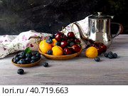 Still life with apricots, cherries and blueberries on a wooden table. Стоковое фото, фотограф Татьяна Ляпи / Фотобанк Лори