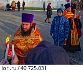 Пасха. Священник раздает прихожанам благодатный огонь около около Успенского собора. Город Владимир (2023 год). Редакционное фото, фотограф Макаров Алексей / Фотобанк Лори