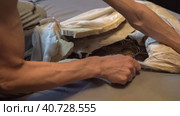 The man cut the spring mattress with a knife. Spring block and foam lining. Стоковое видео, видеограф Андрей Знаменский / Фотобанк Лори