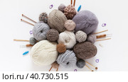 Video of natural wool yarn in beige, brown, gray, white colors, wooden knitting needles, crochet  hooks on white background. Circular composition. DIY concept. Knitting as hobby. Flat lay, close-up, top view. Стоковое видео, видеограф Виктория Катьянова / Фотобанк Лори