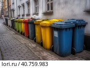 Multi-colored garbage containers on the city street, recycling and separate waste collection concept, AI Generated. Стоковое AI-изображение, AI-художник Станислав Тарко / Фотобанк Лори