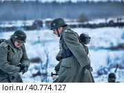 LENINGRAD REGION, RUSSIA - JANUARY 22, 2012: The german gunners during the Second world war to occupy the position. Military-historical reconstruction of the battle that broke the siege of Leningrad. Редакционное фото, фотограф Анна Кривицкая / Фотобанк Лори