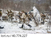 LENINGRAD REGION, RUSSIA - JANUARY 22, 2012: The german gunners during the Second world war to occupy the position. Military-historical reconstruction of the battle that broke the siege of Leningrad. Редакционное фото, фотограф Анна Кривицкая / Фотобанк Лори