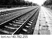 Railways. Metal steel rails and wooden sleepers. Rivets and fasteners on the railroad. Stony backfill of railway tracks. Station Nyrki, Karelia. Стоковое фото, фотограф Юлия Петровская / Фотобанк Лори