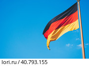 German national flag on blue sky background. Стоковое фото, фотограф Igor Tichonow / Фотобанк Лори