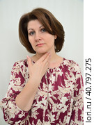 woman holds her hand on her neck - concept of diseases - tonsillitis, hyperthyroidism and others. Стоковое фото, фотограф Володина Ольга / Фотобанк Лори