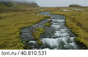 Aerial flight through epic Iceland landscape over the Foss river. Scandinavian amazing nature. Стоковое видео, видеограф Igor Tichonow / Фотобанк Лори