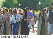 Moscow, Russia - June 12, 2023: Street photography. People walk on the city street in sunny summer day. Lifestyle concept. A lot of people. Fashionable women. Defocused child on the background. Редакционное фото, фотограф YuryKara / Фотобанк Лори