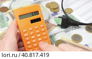 Person Counting and Calculate Cost Money of Electricity and Heating Bill. Electric Cap, Light Bulb and Euro Banknotes on the Background. Increase in the Cost of Electricity. Price Hike. Energy Crisis. Стоковое видео, видеограф Марина Демидюк / Фотобанк Лори