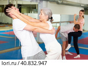 Senior woman performing eye-gouging move during self-defence training. Стоковое фото, фотограф Яков Филимонов / Фотобанк Лори