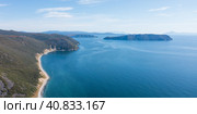 Aerial view of the sea coast. Beautiful panoramic landscape. A mountainous island in the distance. Nature of Siberia and the Russian Far East. Taui Bay, Sea of Okhotsk, Magadan Region, Russia. Стоковое фото, фотограф Андрей Степанов / Фотобанк Лори