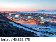 Anadyr, Chukotka, Far North of Russia. Beautiful cityscape. View from the slope of the hill to the town in the Arctic. Multicolored colorful buildings. Snow-covered northern city. Редакционное фото, фотограф Андрей Степанов / Фотобанк Лори