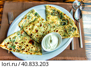 Kutabs or Gozleme - traditional Azerbaijani flatbreads with herbs and cheese. Served with sour cream. Стоковое фото, фотограф Евгений Ткачёв / Фотобанк Лори