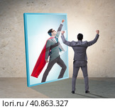 Businessman seeing himself in mirror as superhero. Стоковое фото, фотограф Elnur / Фотобанк Лори