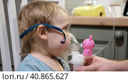 Sick Baby Girl with making Inhalation with a Mask on his Face sitting in Living Room at Home. Children Healing. Child Inhalation therapy with Compressor nebulizer. Inhaling fumes medication into lungs. Стоковое видео, видеограф Марина Демидюк / Фотобанк Лори