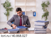 Young male employee and too much work in the office. Стоковое фото, фотограф Elnur / Фотобанк Лори