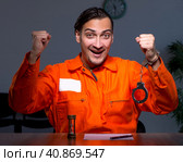 Young convict man sitting in dark room. Стоковое фото, фотограф Elnur / Фотобанк Лори