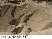 Sandstone is a fragmentary sedimentary rock, a homogeneous or layered aggregate of fragmentary grains and grains of sand bound by any mineral substance, cement. Quarry natural yellow sand wall. Стоковое фото, фотограф Юлия Петровская / Фотобанк Лори
